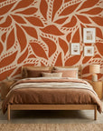Rust Echoes bold leaf wallpaper adding character to a cozy bedroom