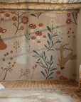 A delightful wallpaper in a peach hue, featuring woodland animals and a vibrant meadow of wildflowers