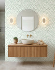 Sage Drop sage green polka dot wallpaper creating ambiance in a serene bathroom