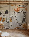 Safari themed wallpaper shown in a modern children’s room with minimalist furniture and warm textures