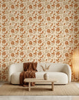 Sienna Drift warm terracotta autumn leaf wallpaper in a warm and inviting living room