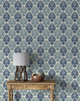 Silent Bouquet removable wallpaper on rustic console with navy and sage damask pattern