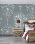 Silent Spring damask wallpaper in sage green with white ornate scrollwork on bedroom accent wall