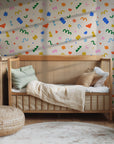 Abstract playful wallpaper shown on a modern nursery wall, featuring colorful shapes that create a cheerful and creative atmosphere.