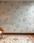 White wall covering showing a subtle design of outlined blue balloons and airy clouds