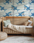 Blue sharks winking on a playful, striped wallpaper design with an aquatic theme.