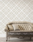 Soft Bouquet Opus wallpaper with beige damask pattern behind elegant tufted sofa in classic living room