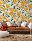 Self-adhesive wallpaper featuring a vibrant orange and yellow painterly floral design, known as Solar Bloom