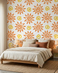 Vibrant orange folk art sun swirl peel and stick wallpaper - Solstice Bloom adding character to a bedroom
