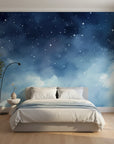 Starlit Dreams watercolor wallpaper with navy blue gradient and white stars on bedroom accent wall