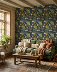 Storybook Forest navy folk woodland wallpaper in a warm and inviting living room