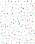 This fun, white wallpaper features brightly colored dots and dashes (sprinkles) widely distributed for a festive appearance