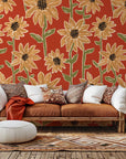 Terracotta red wall covering adorned with a hand-drawn pattern of bright yellow sunflowers