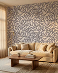 Swirling Echoes fluid foliage wallpaper in a warm and inviting living room