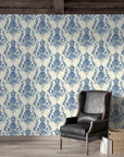 Blue and cream Sylvan Elegance damask wallpaper in rustic living room with leather chair