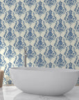 Blue and cream Sylvan Elegance damask wallpaper in modern bathroom with freestanding tub
