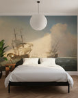Maritime scene wallpaper featuring tall ships in sepia tones on bedroom accent wall