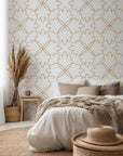 Floral quatrefoil design detailed with thin gold lines against a light backdrop