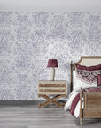 Tranquil Flora damask wallpaper in soft gray and white tones applied to elegant bedroom accent wall