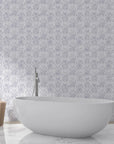 Tranquil Flora damask wallpaper in soft lavender and white behind modern freestanding bathtub