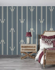 Slate blue and cream Art Deco stripe wallpaper with geometric arrow motifs in elegant bedroom setting
