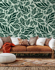 Dark green wallpaper showcasing a thick, botanical pattern of closely packed tropical leaves