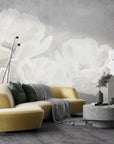 Oversized white flowers on gray textured background create soft watercolor mural wallpaper in modern living room