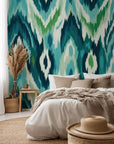 Peel and stick wallpaper featuring an abstract wave pattern in blue and green Ikat style.