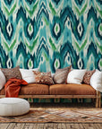 Abstract blue and green Ikat wave self-adhesive wall covering labeled "Woven Depths"