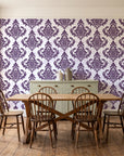 Antique Fern Mist Aubergine distressed damask wallpaper in a farmhouse dining room with a sage sideboard and rustic trestle table