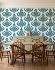 Antique Fern Mist Teal distressed damask wallpaper in a farmhouse dining room with a sage sideboard and rustic trestle table