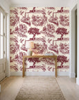 Arcadian Reverie Claret pastoral toile wallpaper behind a console table in a light entry hallway