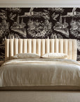 Arcadian Reverie Espresso pastoral toile wallpaper behind a channel-tufted bed in a calm primary bedroom