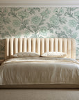 Blush Serenade Garden floral damask wallpaper behind a channel-tufted bed in a calm primary bedroom