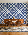 Carbon Bloom Navy tile floral wallpaper in a mid-century dining room with a teak sideboard and tulip table