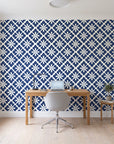 Carbon Bloom Navy tile floral wallpaper behind a modern oak desk in a bright home office