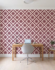 Carbon Bloom Oxblood tile floral wallpaper behind a modern oak desk in a bright home office