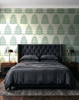Clipped Dreams Forest tree wallpaper behind a tufted headboard in a dark, moody bedroom