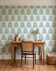 Clipped Dreams Forest tree wallpaper behind a vintage writing desk in a cozy craft-room home office