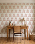 Clipped Dreams Terracotta tree wallpaper behind a vintage writing desk in a cozy craft-room home office