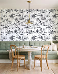 Coastal Village Charcoal palm toile wallpaper as a feature wall in a sunlit breakfast nook
