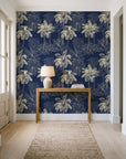 Conservatory Greens Midnight tropical palm toile wallpaper behind a console table in a light entry hallway
