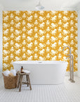 Cresting Wave Saffron octopus wallpaper behind a freestanding tub in a bright coastal bathroom