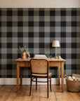 Dune Plaid Charcoal gingham check wallpaper behind a vintage writing desk in a cozy craft-room home office