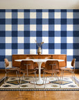 Dune Plaid Navy gingham check wallpaper in a mid-century dining room with a teak sideboard and tulip table