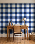 Dune Plaid Navy gingham check wallpaper behind a vintage writing desk in a cozy craft-room home office