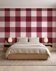 Dune Plaid Oxblood gingham check wallpaper behind a low platform bed in a serene Japandi bedroom