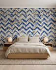 Dusk Passage Indigo chevron wallpaper behind a low platform bed in a serene Japandi bedroom