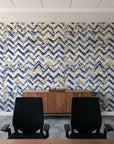 Dusk Passage Indigo chevron wallpaper above a walnut credenza in a modern conference room