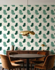 Dust & Wing Emerald butterflies wallpaper behind a walnut credenza and round table in an elegant dining room